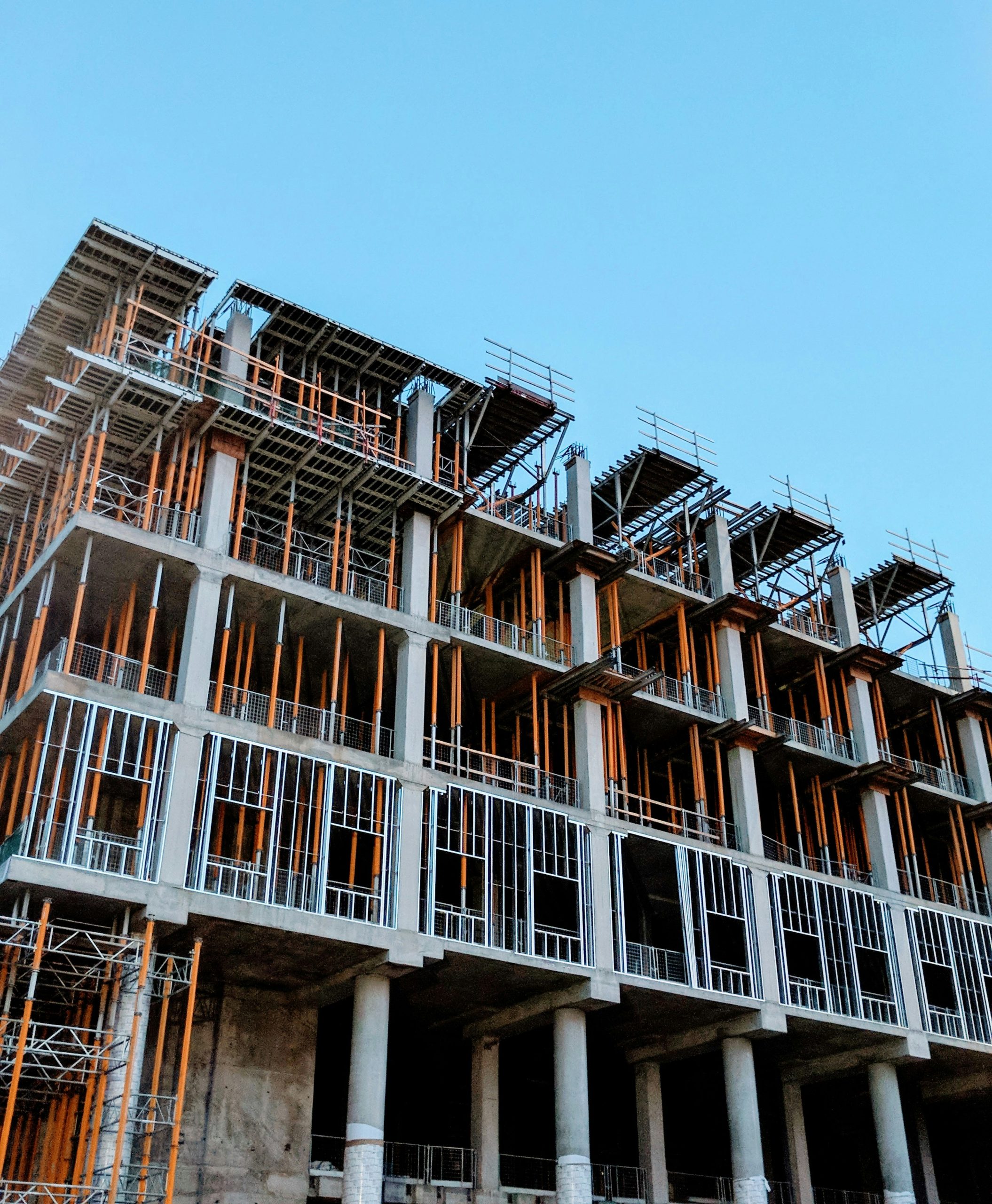image of multistorey construciton of building against the blue sky